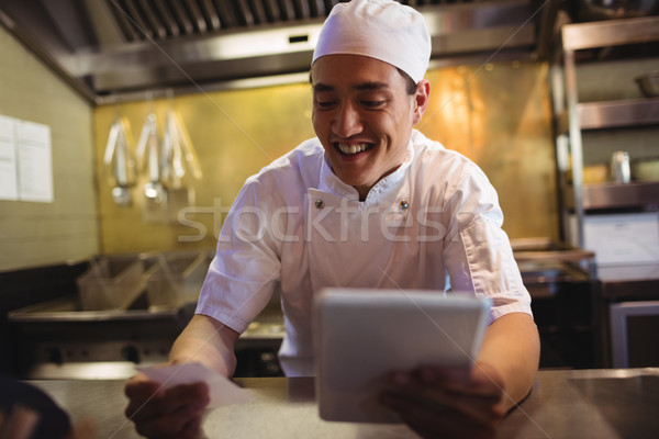 Chef looking at an order list in the commercial kitchen Stock photo © wavebreak_media