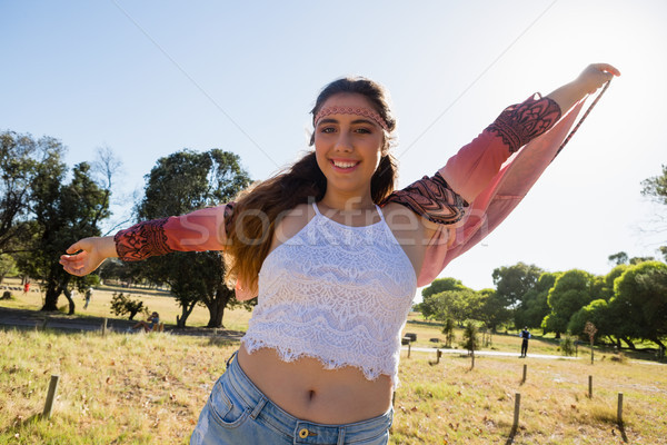 Stock photo: Woman standing with arms outstretched in the park
