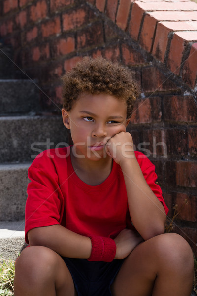 Upset boy sitting on staircase in the boot camp Stock photo © wavebreak_media