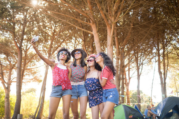 Happy female friends taking selfie at campsite Stock photo © wavebreak_media