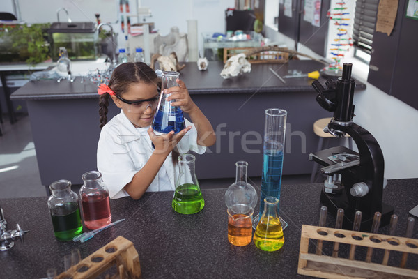 High angle view of elementary student examining blue chemical in flask at laboratory Stock photo © wavebreak_media