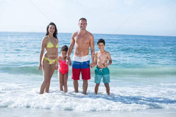 Family standing in shallow water at beach Stock photo © wavebreak_media
