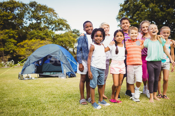 Smiling kids posing together during a sunny day Stock photo © wavebreak_media