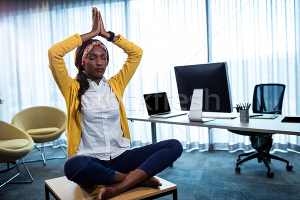 Businesswoman doing yoga  Stock photo © wavebreak_media