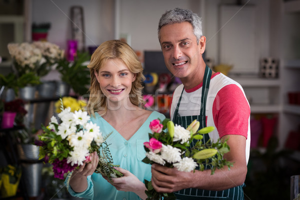 Smiling florists holding bunch of flowers in flower shop Stock photo © wavebreak_media