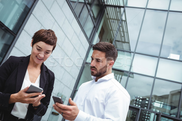 Businesspeople using mobile phone Stock photo © wavebreak_media