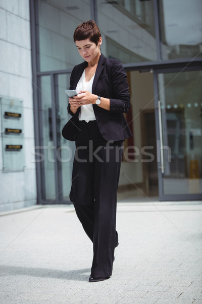 Businesswoman using mobile phone Stock photo © wavebreak_media