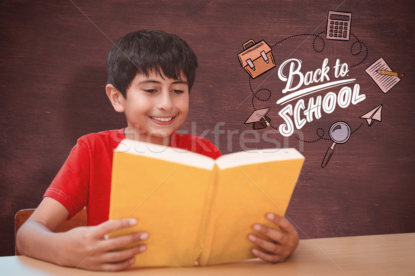 Composite image of cute boy reading book in library Stock photo © wavebreak_media