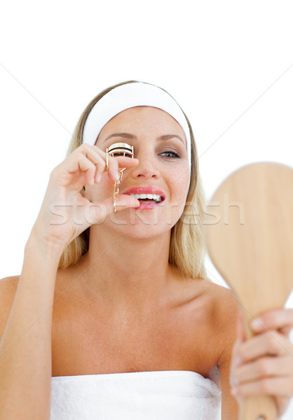 Beautiful woman using an eyelash curler Stock photo © wavebreak_media