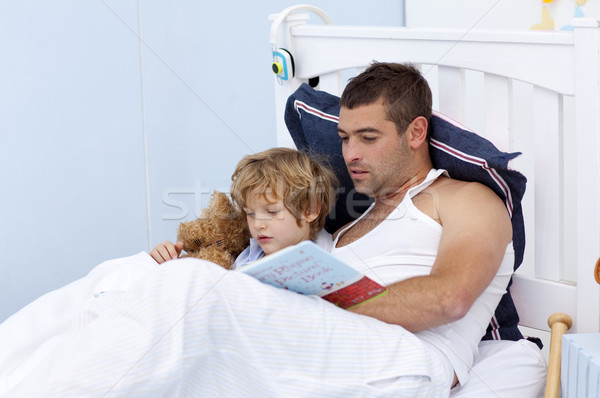 Father and son reading a book in bed Stock photo © wavebreak_media