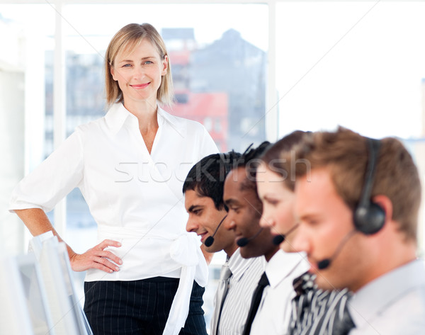 Bright female leader managing her concentrated team in a call center Stock photo © wavebreak_media