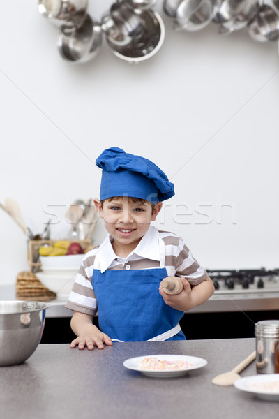 Little boy with blue hat and apron baking Stock photo © wavebreak_media