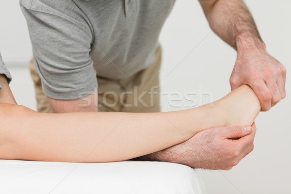Physiotherapist stretching the ankle of a patient in a room Stock photo © wavebreak_media