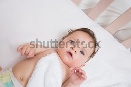 Baby falling asleep in the arms of her mother in a bedroom Stock photo © wavebreak_media