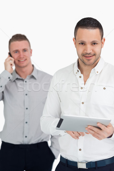 Dwa uśmiechnięty mężczyzn telefonu biały Zdjęcia stock © wavebreak_media