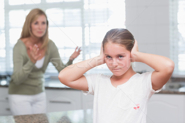 Upset little girl covering her ears while her mother screaming  Stock photo © wavebreak_media