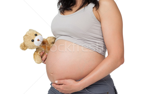 Stock fotó: Terhes · nő · megérint · dudorodás · tart · plüssmaci · fehér