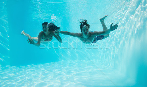 Couple holding hands and swimming underwater Stock photo © wavebreak_media