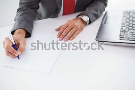 Mature businessman writing on document Stock photo © wavebreak_media
