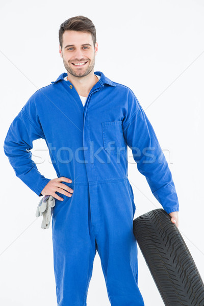 Smiling male mechanic holding tire Stock photo © wavebreak_media