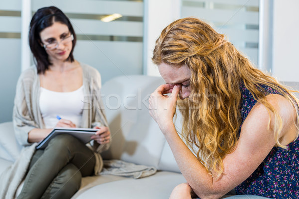 Stock photo: Psychologist talking with her depressed patient