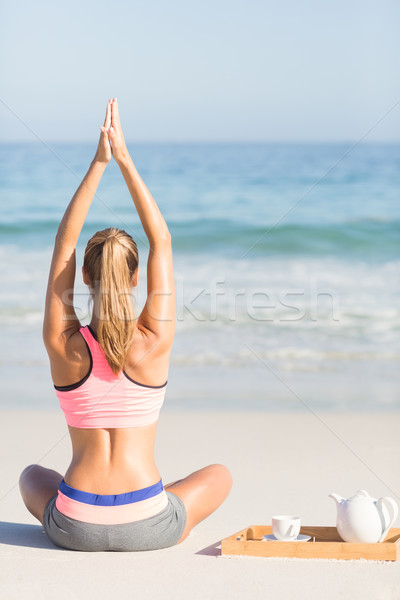 Stock photo: Fit woman doing yoga beside the sea 