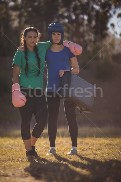 Portrait of confident friends standing with arms around during obstacle course Stock photo © wavebreak_media