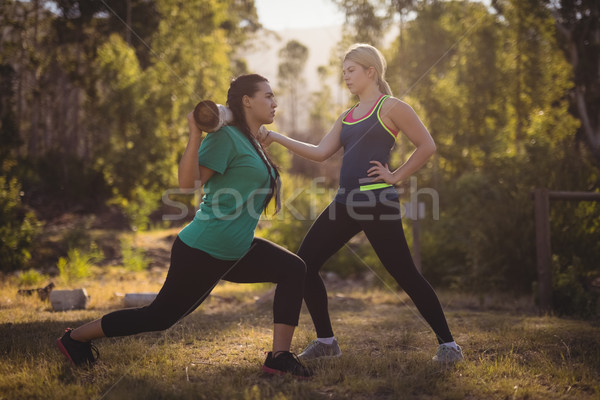 Trainer assisting woman in exercising Stock photo © wavebreak_media