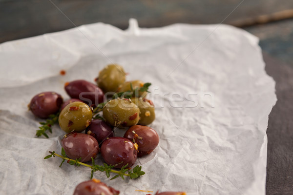 High angle view of olives with thyme on paper Stock photo © wavebreak_media