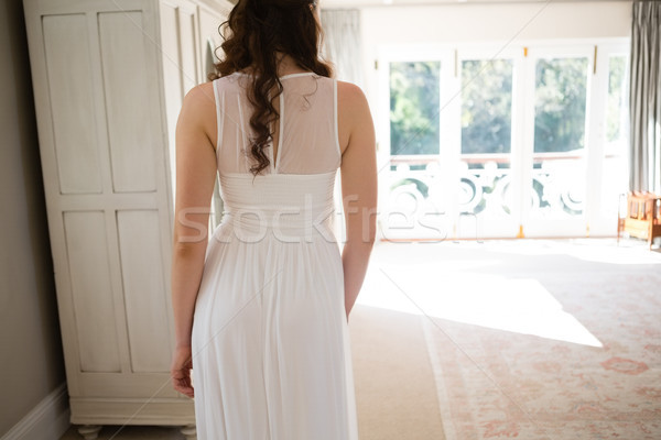 Mariée robe de mariée permanent maison vue arrière femme [[stock_photo]] © wavebreak_media