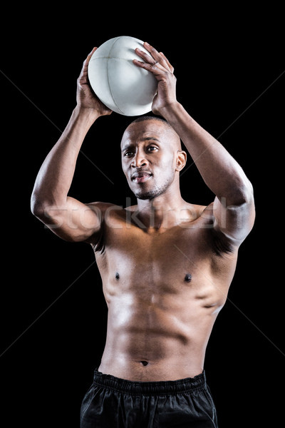 Shirtless athlete throwing rugby ball Stock photo © wavebreak_media