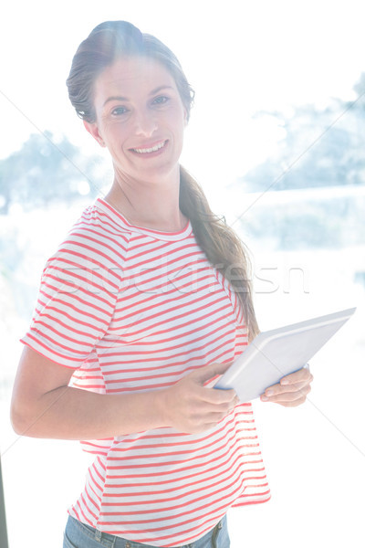 Gülümseyen kadın ayakta içinde pencere Stok fotoğraf © wavebreak_media
