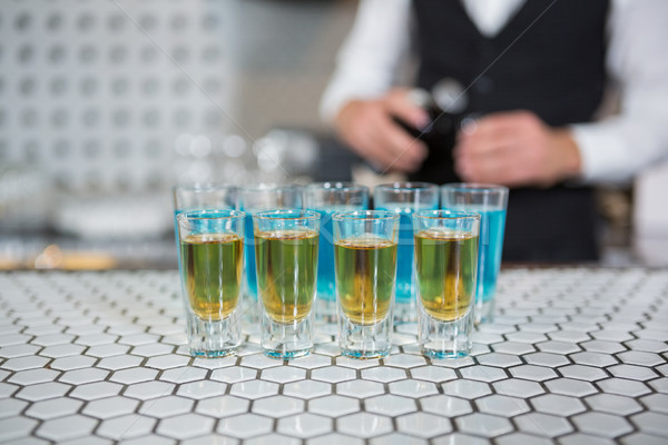 Glass of blue lagoon drinks and whisky on bar counter Stock photo © wavebreak_media