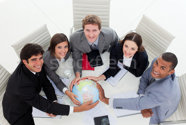 Smiling Business team holding a terrestrial globe Stock photo © wavebreak_media