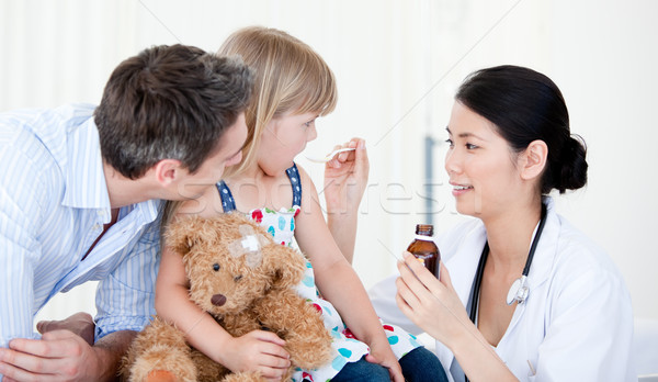 Professional female doctor giving syrup to a little girl  Stock photo © wavebreak_media