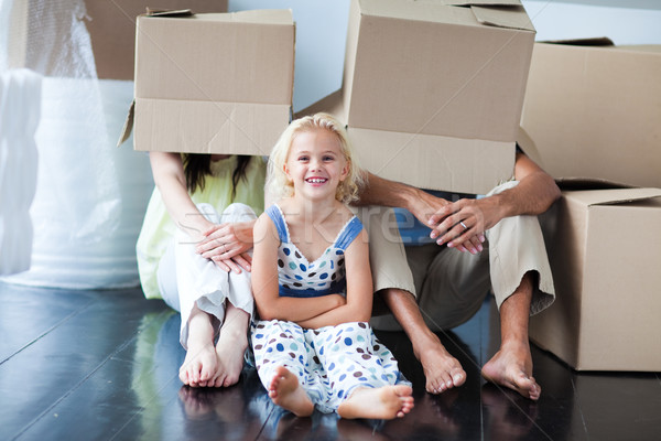 Parents and daughter playing at home with boxes Stock photo © wavebreak_media