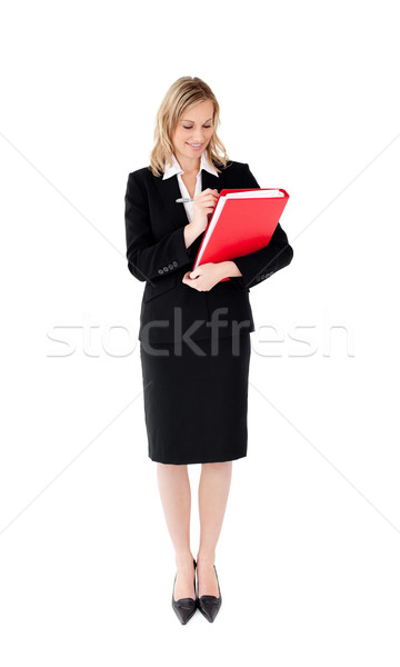 Radiant businesswoman writing on a paper against white background Stock photo © wavebreak_media