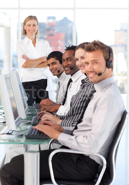 Stock photo: Cheerful manager leading her representative team in a office