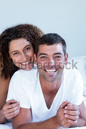 Pretty woman hugging her husband on their bed at home Stock photo © wavebreak_media
