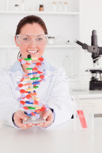 Portrait of a beautiful scientist showing the dna double helix model Stock photo © wavebreak_media