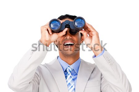 Joyful businesswoman predicting future success through binoculars isolated on a white background Stock photo © wavebreak_media