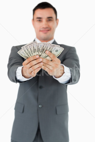 Businessman presenting his banknotes against a white background Stock photo © wavebreak_media