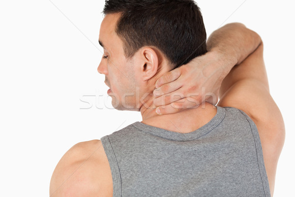 Stock photo: Young man having a back pain against a white background