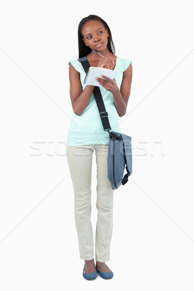 Young student with scratchpad thinking against a white background Stock photo © wavebreak_media
