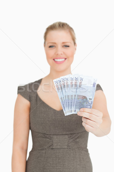 Woman showing her euro banknotes against white background Stock photo © wavebreak_media