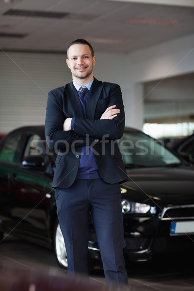 Salesman standing in front of car in a dealership Stock photo © wavebreak_media
