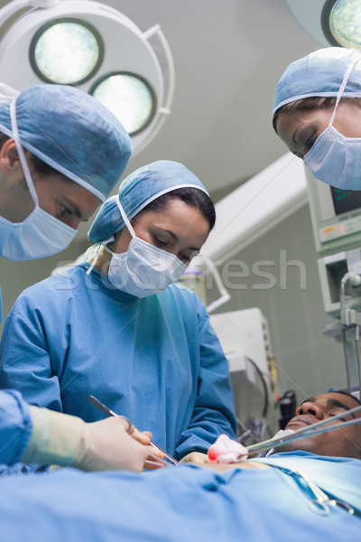 Doctors operating with surgical tools in operating theater Stock photo © wavebreak_media