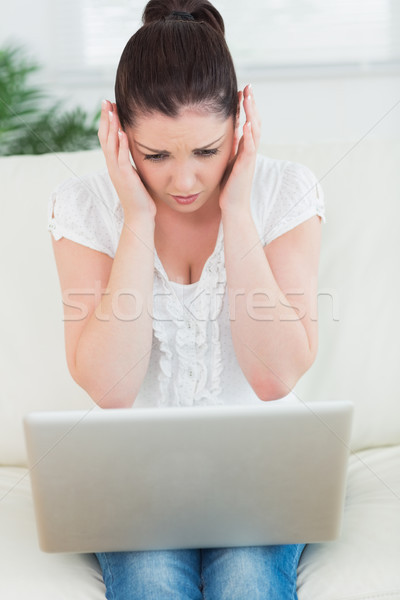 Túlterhelt nő ül kanapé nappali laptopot használ Stock fotó © wavebreak_media