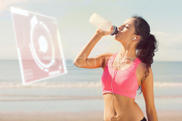 Composite image of beautiful healthy woman drinking water on bea Stock photo © wavebreak_media