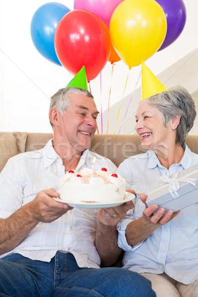 Couple de personnes âgées séance canapé célébrer anniversaire maison [[stock_photo]] © wavebreak_media